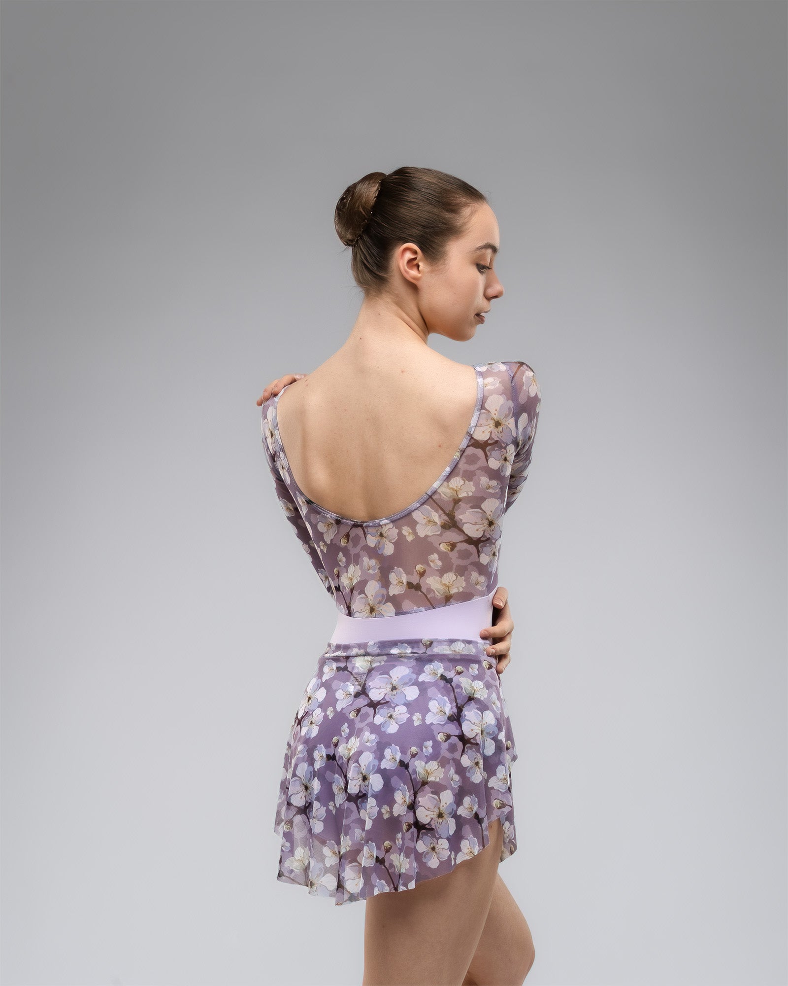 Ballet dancer wearing lilac leotard With long sleeves, floral print mash upper body lilac white and purple With matching Ballet skirt