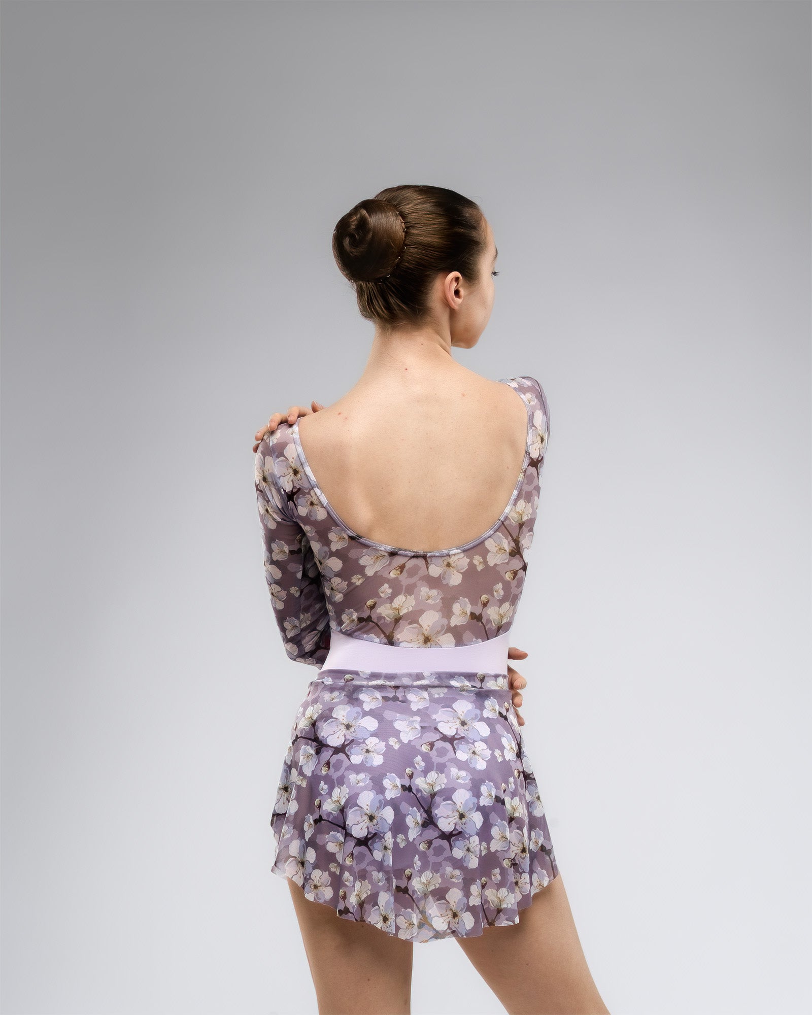 Dancer wearing lilac and purple floral pattern print floaty mesh SAB ballet skirt with matching leotard set
