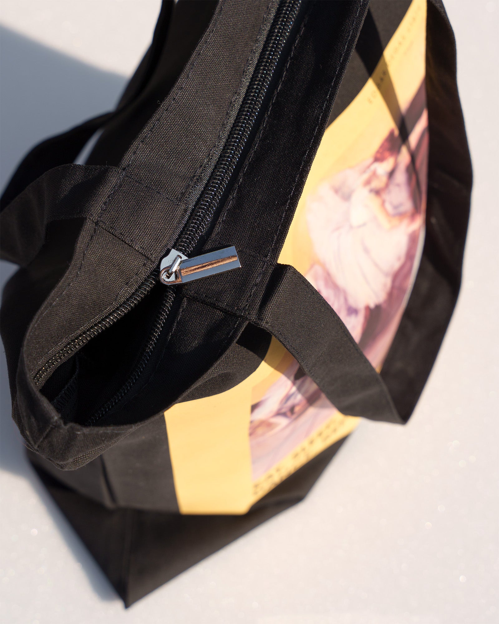 Black dance bag with a zipper on a light background