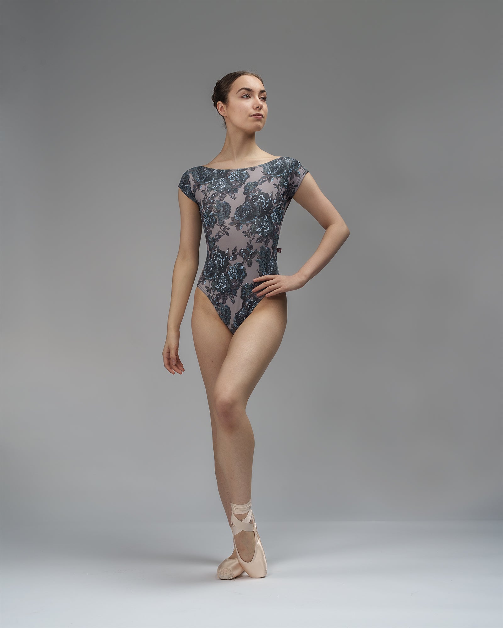 Dancer wearing a black and grey floral leotard