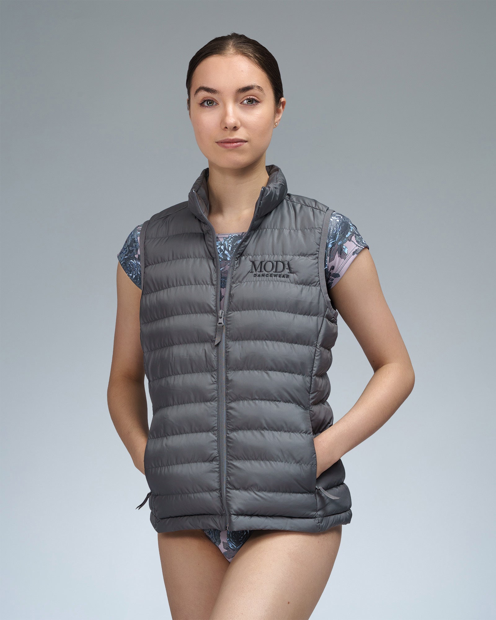 Dancer wearing a grey gilet body warmer over a leotard