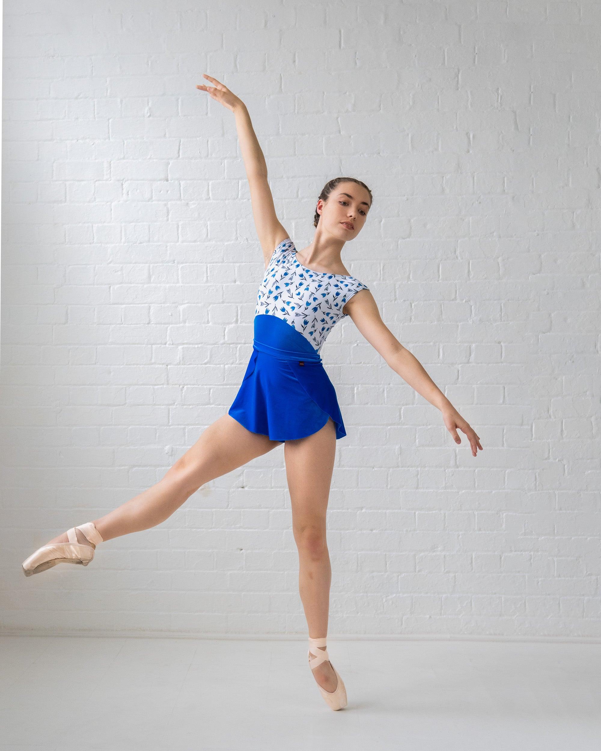 Dancer wearing floral print and royal blue velvet leotard With matching velvet skirt