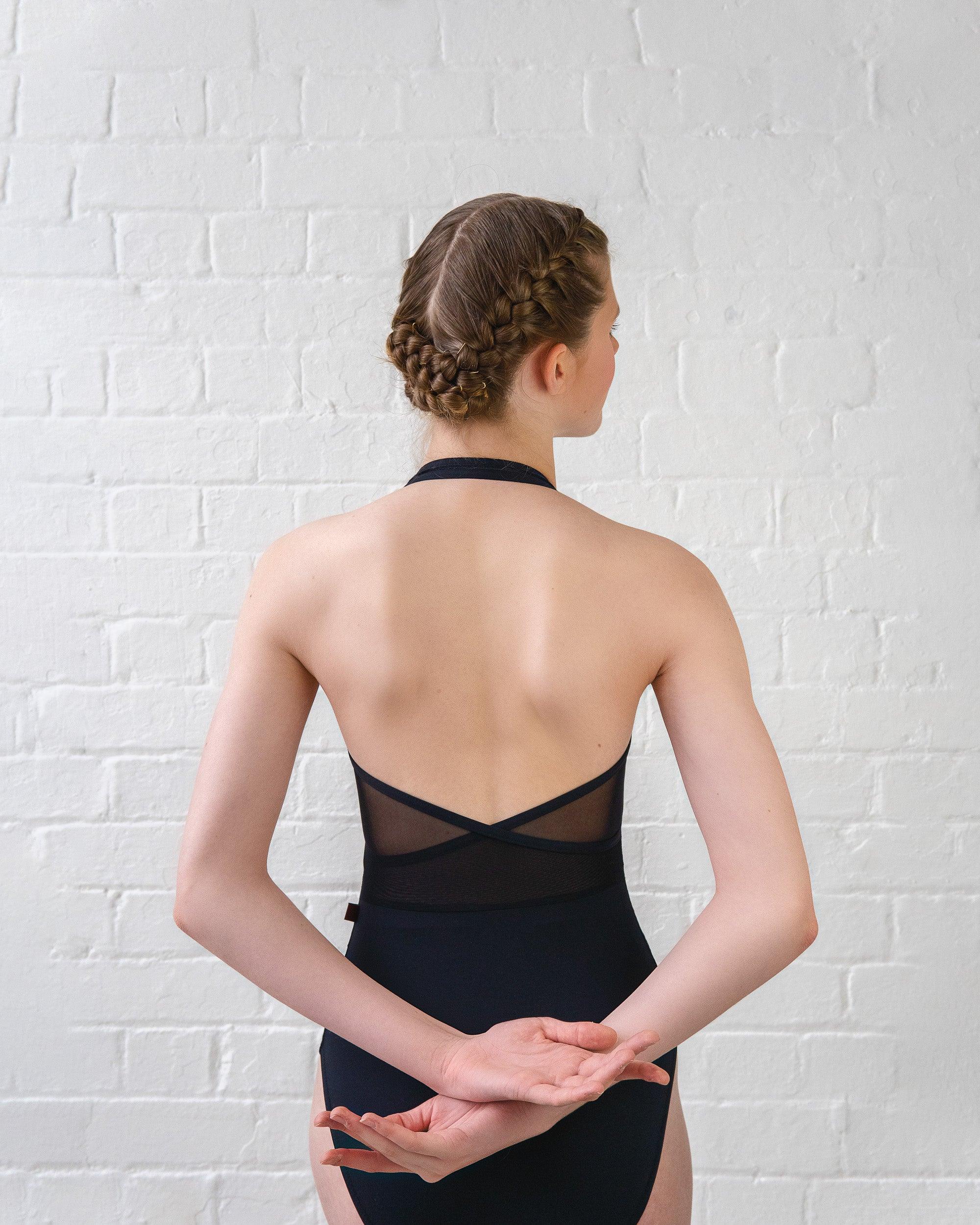 Dancer wearing black halter neck leotard with crushed velvet contour side panels