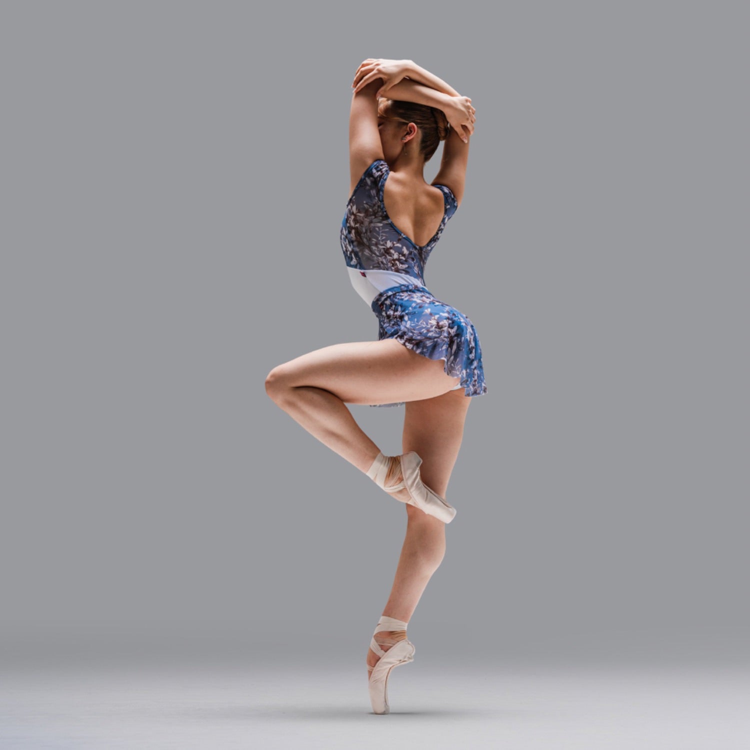 Play Dancer impose on pointe wearing a blue and white floral print leotard with matching SAB skirt