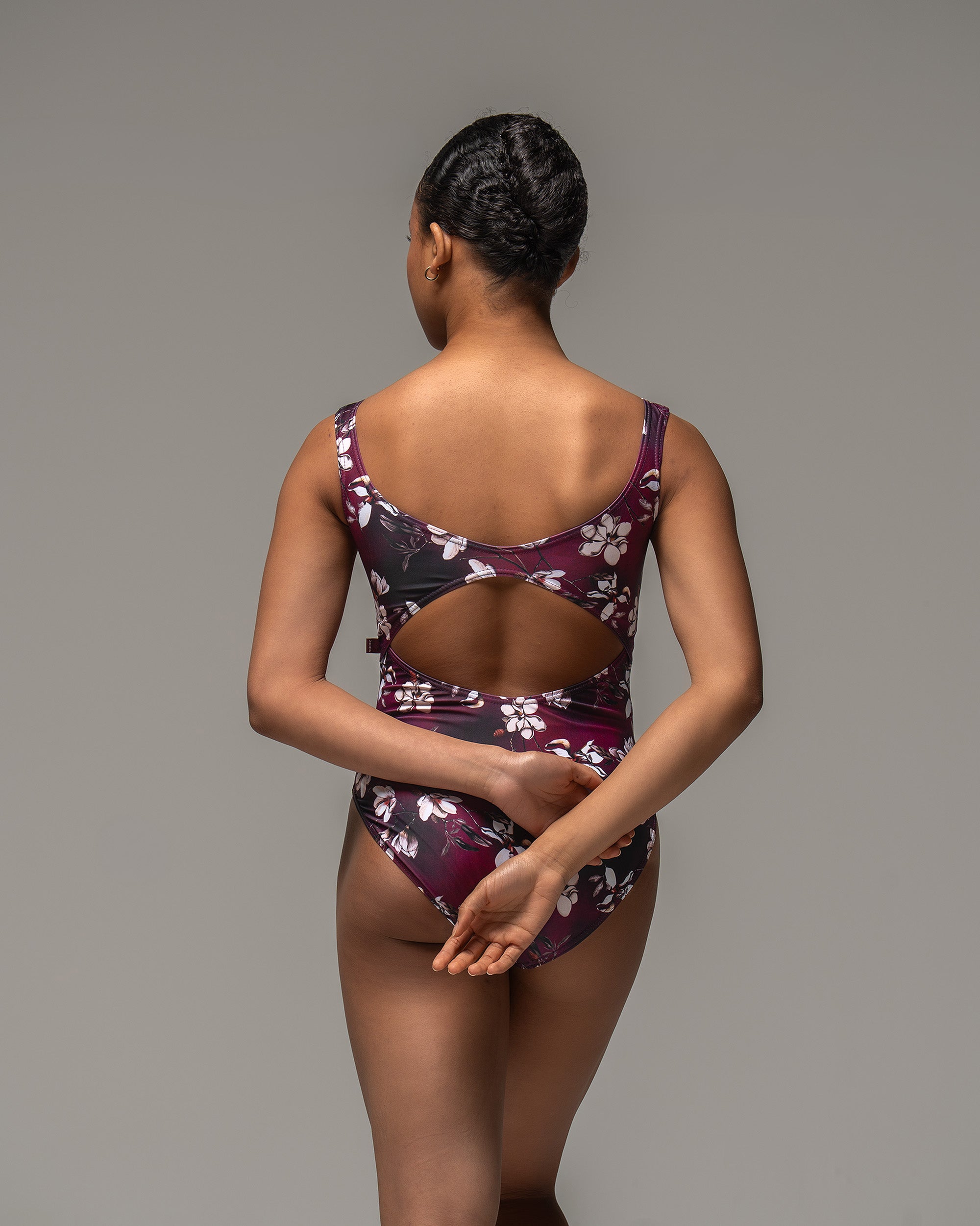 Dancer wearing mulberry wine red Floral print leotard with open back