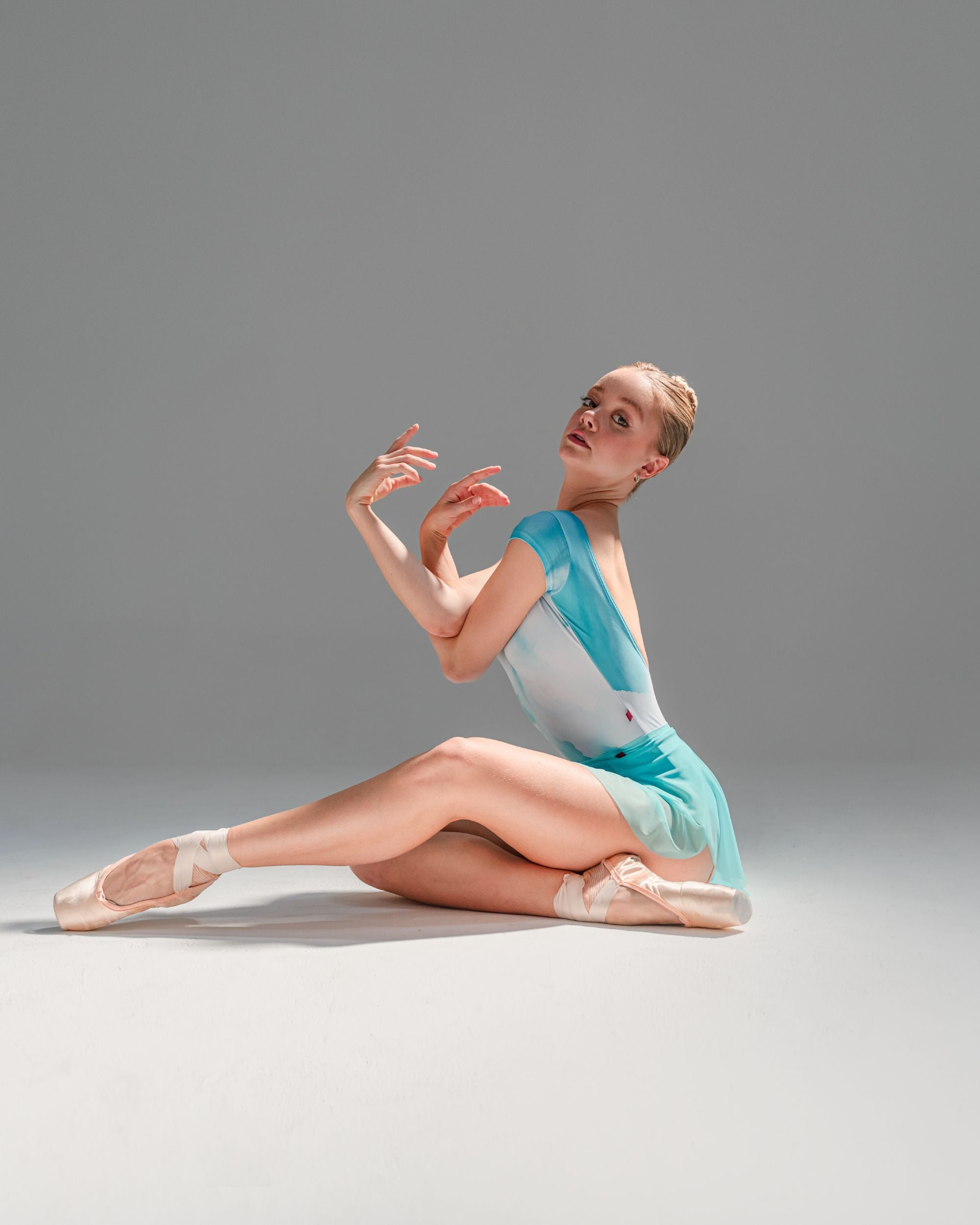 Ballet dancer wearing aqua blue colour mesh SAB ballet skirt and matching aqua low back leotard 