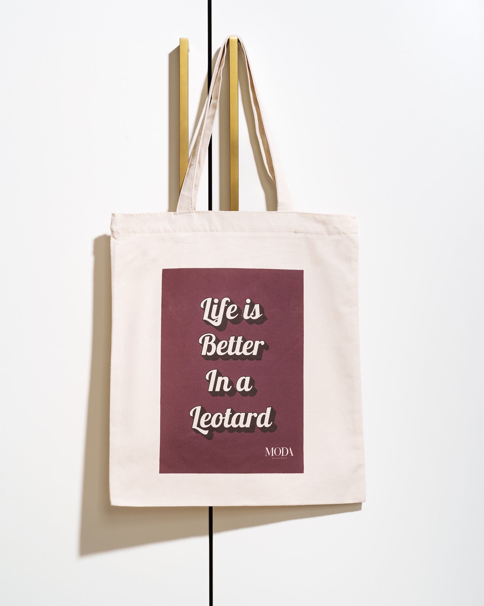 Tote bag with 'Life is Better In a Leotard' text on a white background. Quirky ballet bag.