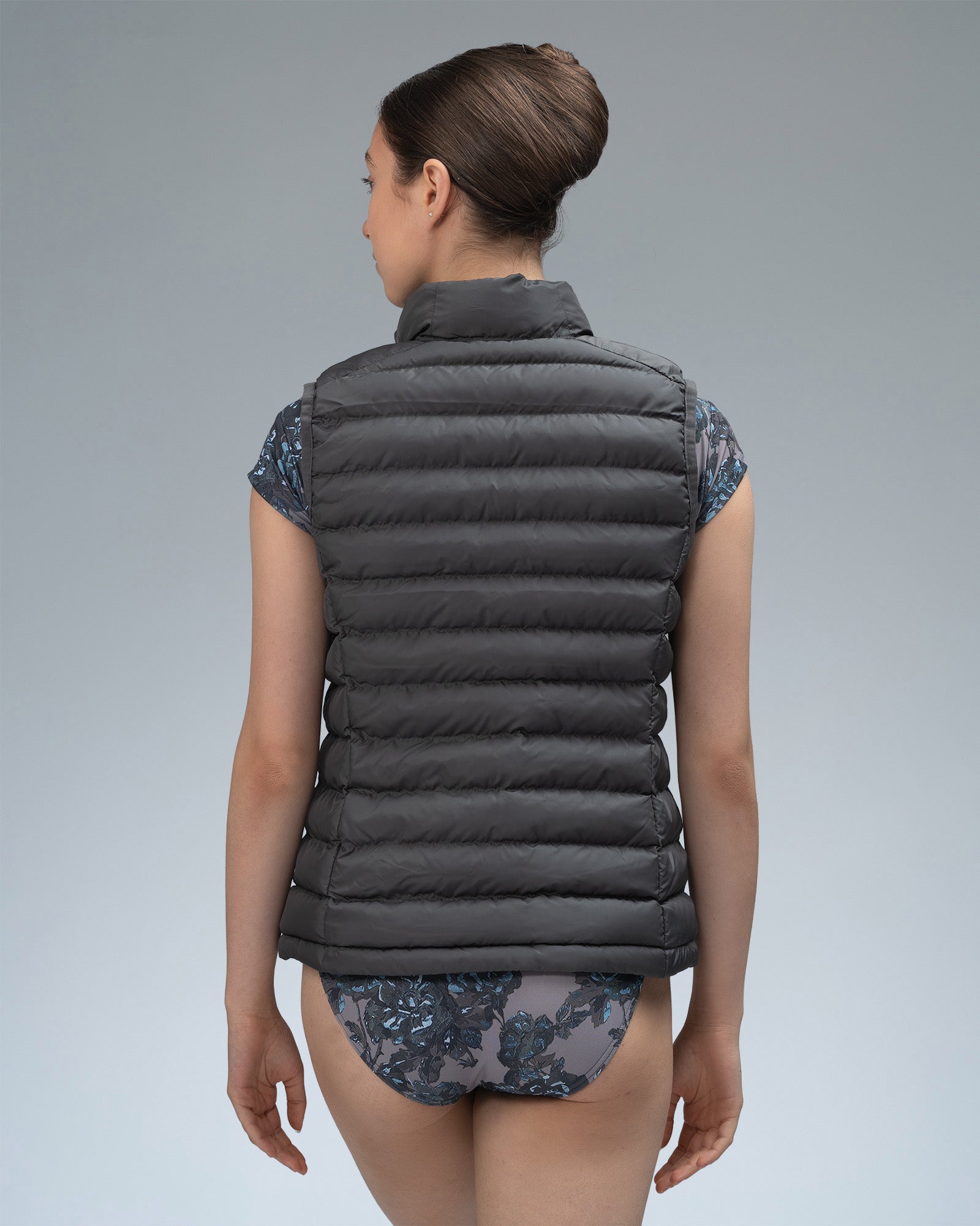 Dancer wearing a grey gilet body warmer over a leotard 